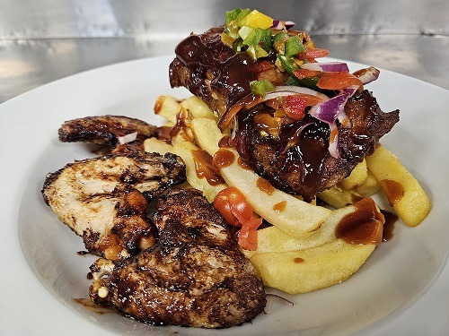 Picture of chicken wings & BBQ Pork Ribs, with chips.